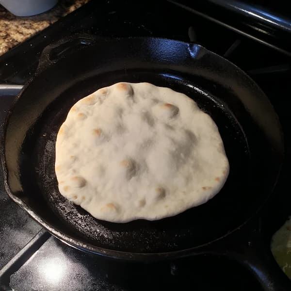 pita bread baking in the skillet
